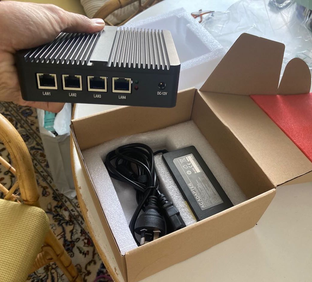 taking mini PC out of package, showing 4 ethernet ports
