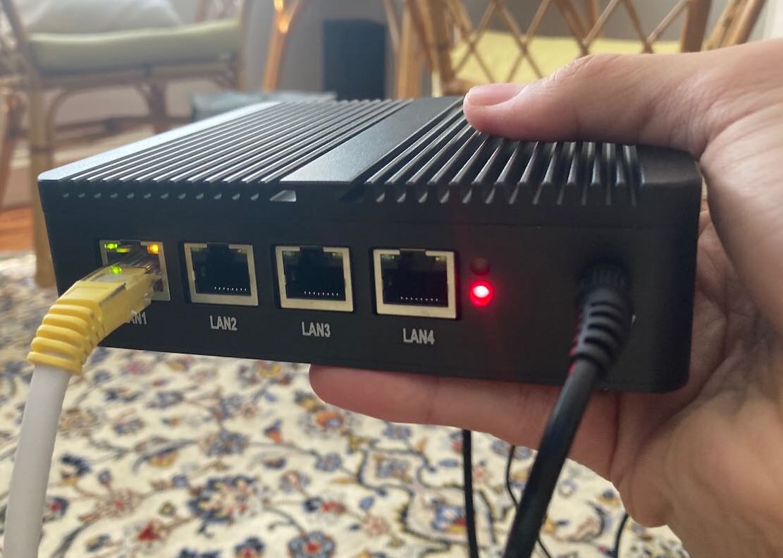 holding mini PC showing ethernet ports